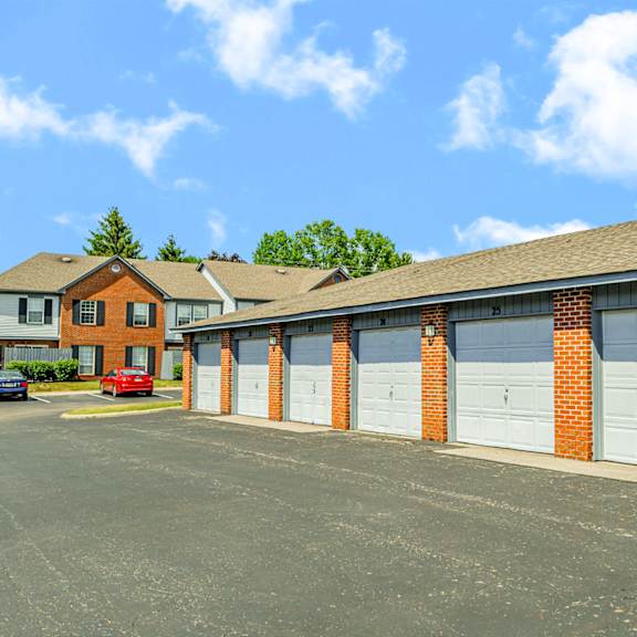a row of garage doors in front of a house