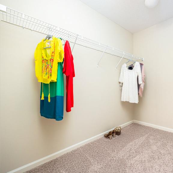a hallway with clothes hanging on the wall.