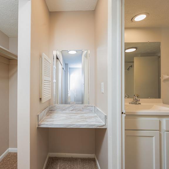 an empty bathroom with a sink and a mirror