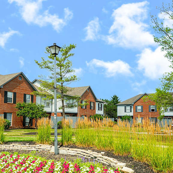 a group of houses with a garden in front of them