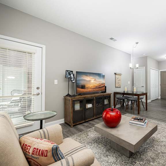 a living room with a couch and a table with a television