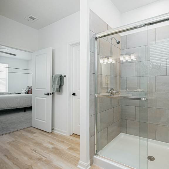 a bathroom with a shower with a glass door