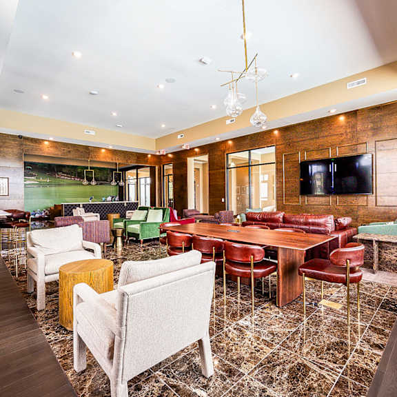 a club room with a table and chairs and a tv