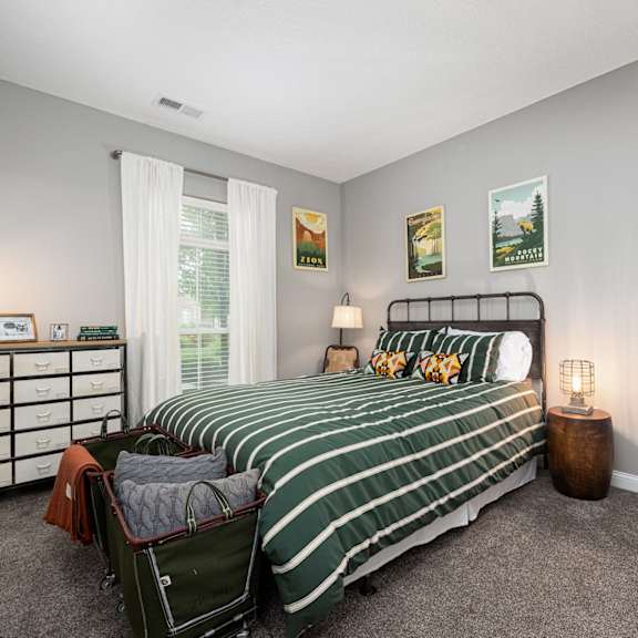 a bedroom with a bed and a dresser