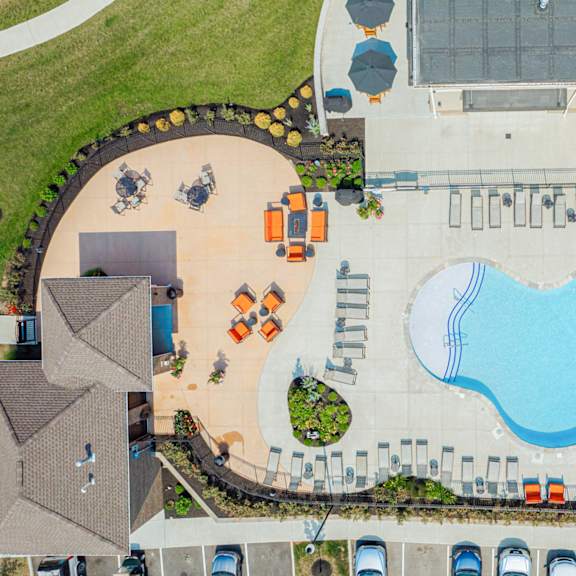 an aerial view of a swimming pool in a parking lot