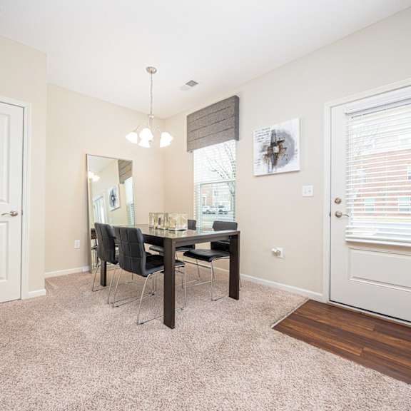 a room with a dining table and chairs.