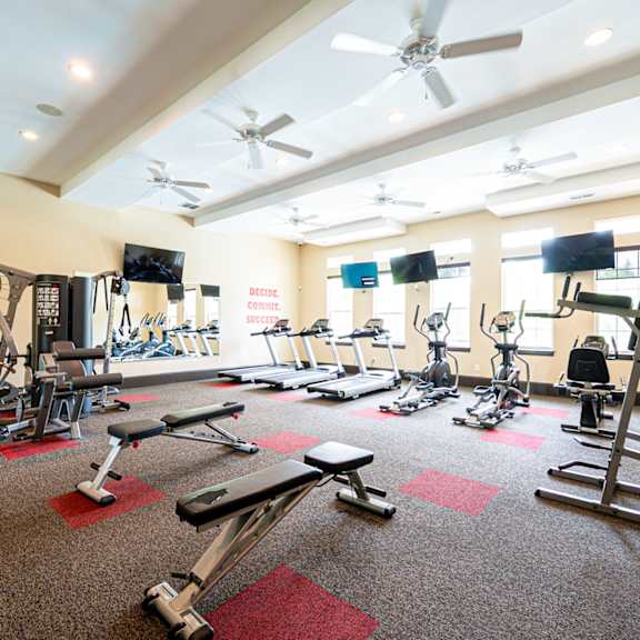 a gym with weights and other exercise equipment in a large room