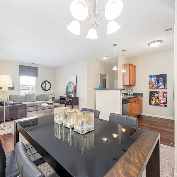 a modern dining room with a glass table and chairs.