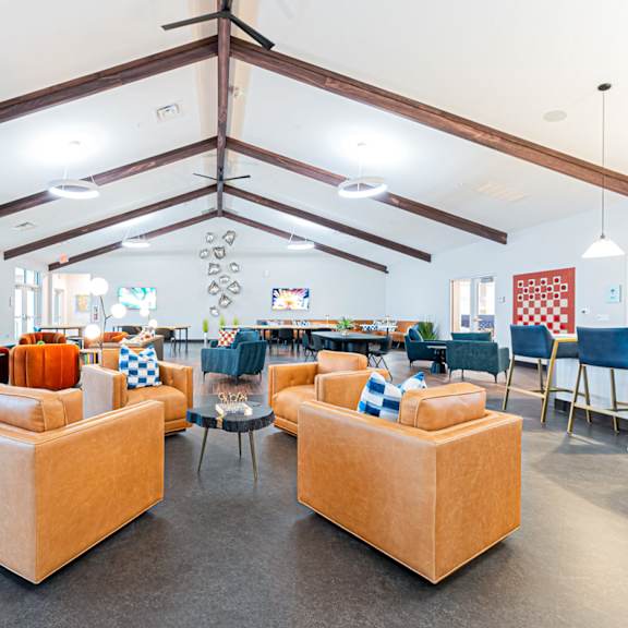 a large room with a pool table and couches.