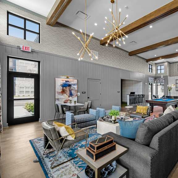 a modern living room with a grey sofa and a wooden coffee table.