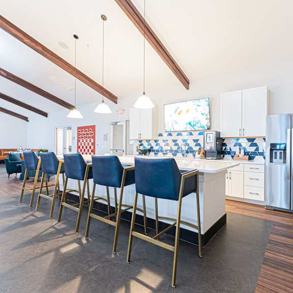 a kitchen with a long table and chairs.