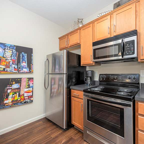 a kitchen with a stainless steel refrigerator, oven, and microwave.