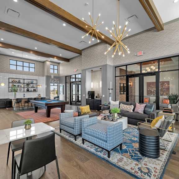 a modern living room with a pool table and a dining table.