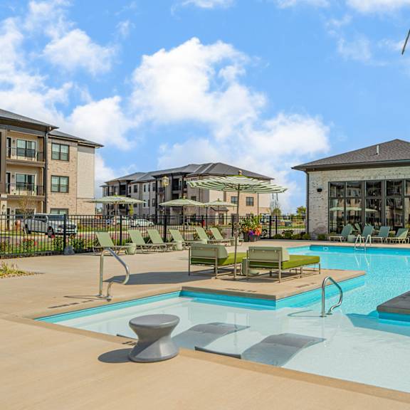 our apartments offer a swimming pool with chairs and umbrellas