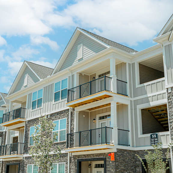 a row of homes with balconies on a sunny day