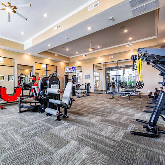 a gym with weights and cardio equipment at the flats