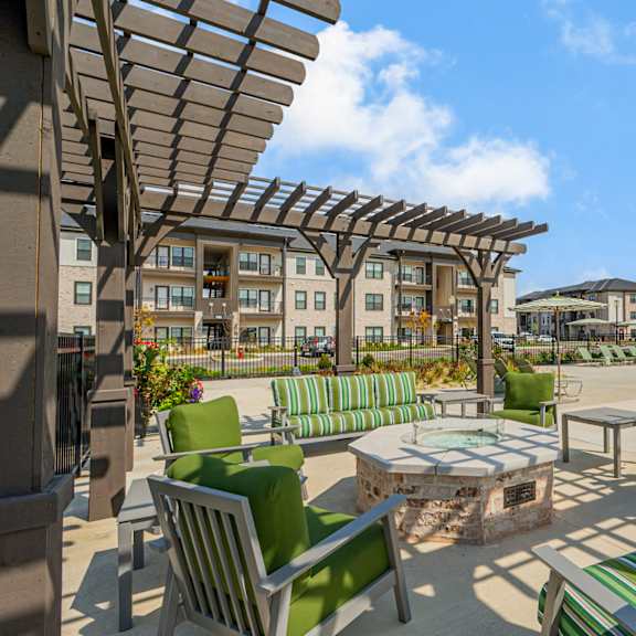 our apartments have a large patio with furniture and a pool