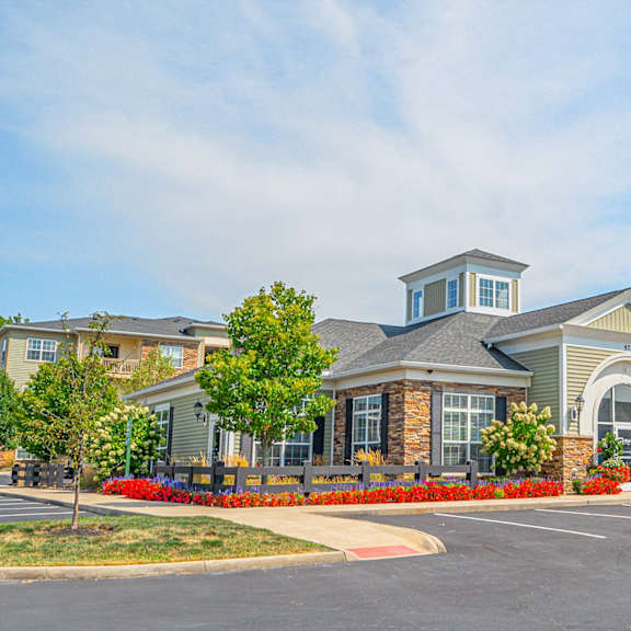 an exterior view of a building with a parking lot