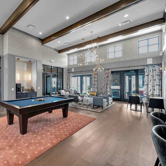 a large room with a pool table and a billiard table.