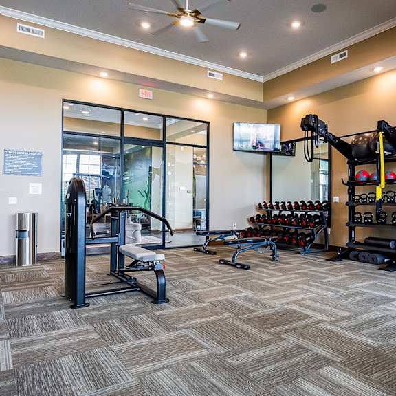 the preserve at ballantyne commons fitness room with weights and a tv
