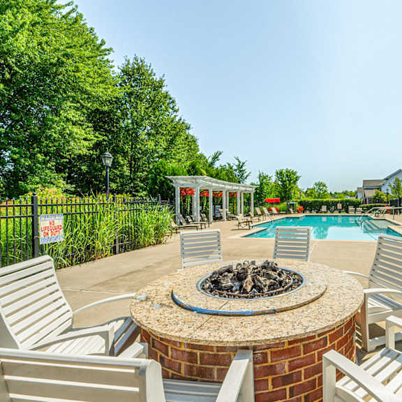 the preserve at ballantyne commons pool and patio with chairs and a fire pit