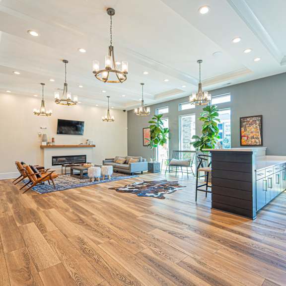 a living room with a fireplace and a table and chairs