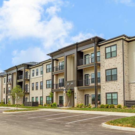 a parking lot in front of an apartment building
