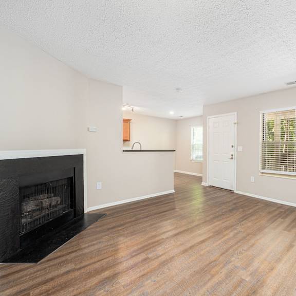 a living room with a fireplace and a window
