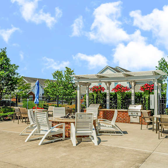 an outdoor patio with tables and chairs and a gazebo