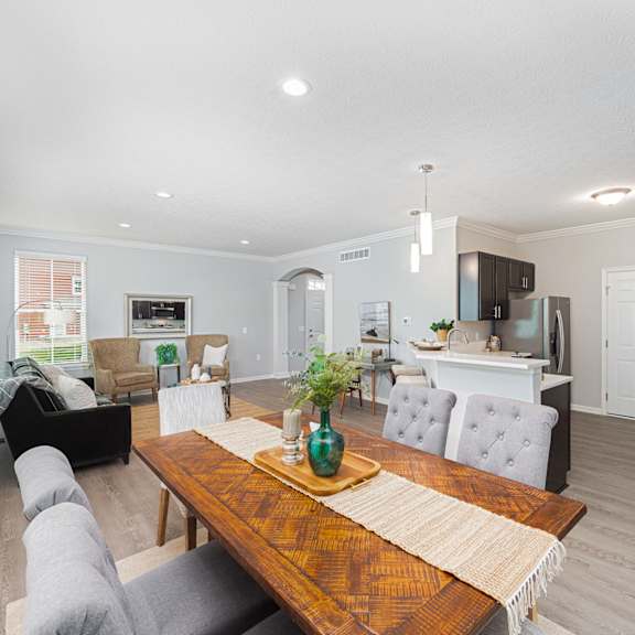 a living room and dining room with a wooden table