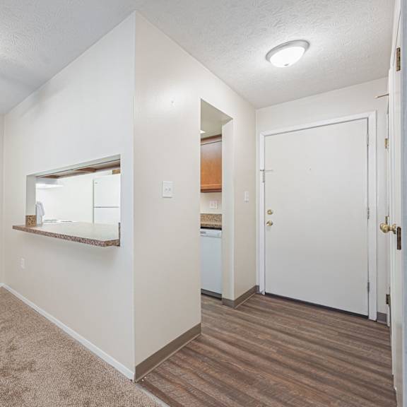 a bedroom with a ceiling fan and a door to a bathroom