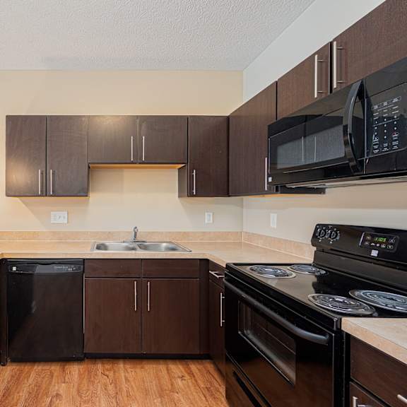 a kitchen with black appliances and a counter top