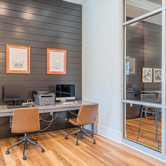 a home office with a desk and a refrigerator