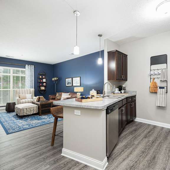 our apartments offer a kitchen and living room with a blue accent wall