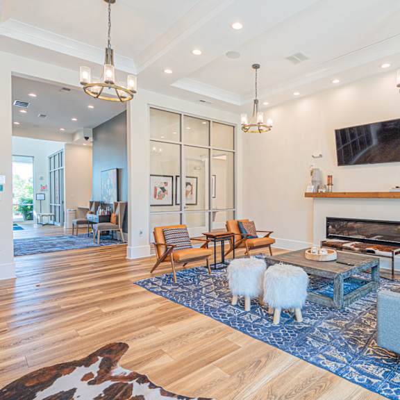 a living room with two sheep in front of a fireplace