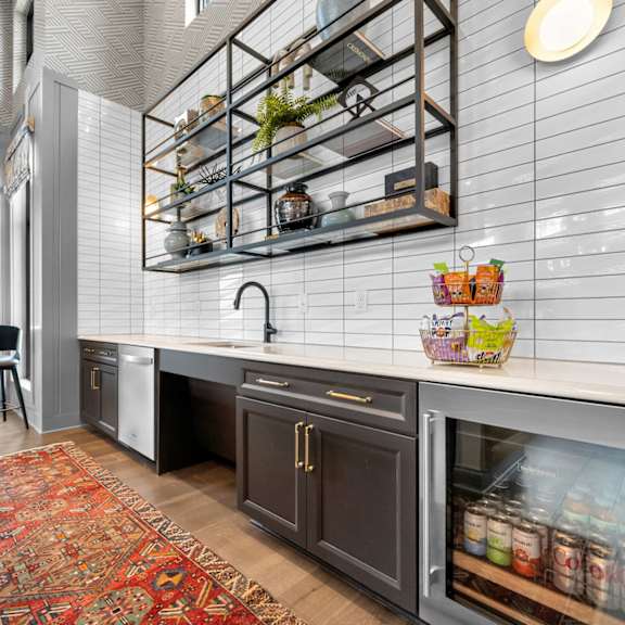 a modern kitchen with a large island and a rug on the floor.