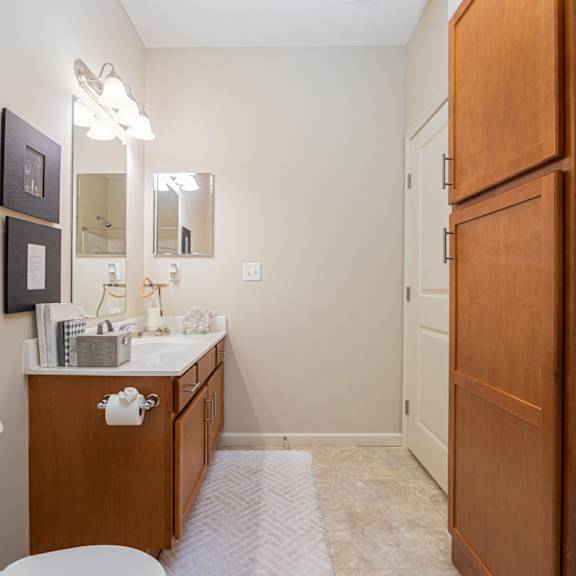 a bathroom with a white tub, sink, and toilet.