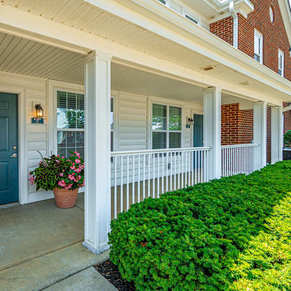 the front porch of a house with a blue door