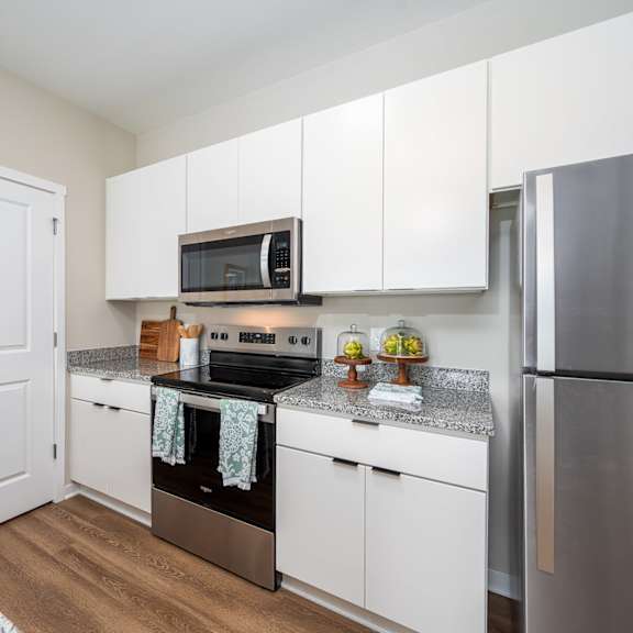 a kitchen with stainless steel appliances and granite counter tops