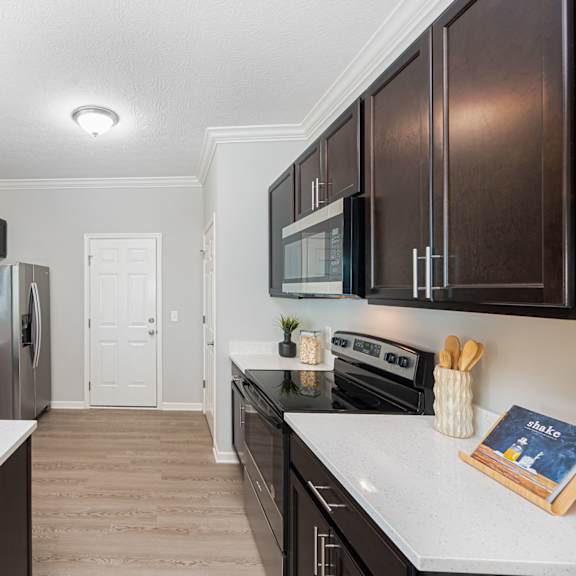 a kitchen with black appliances and white counter tops
