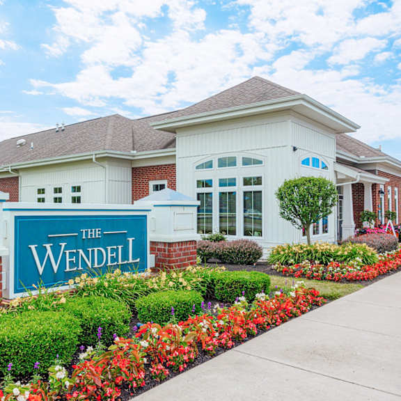 the residences at the wendel building entrance with flowers and plants