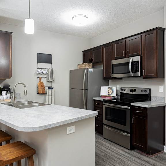 a kitchen with stainless steel appliances and a marble counter top
