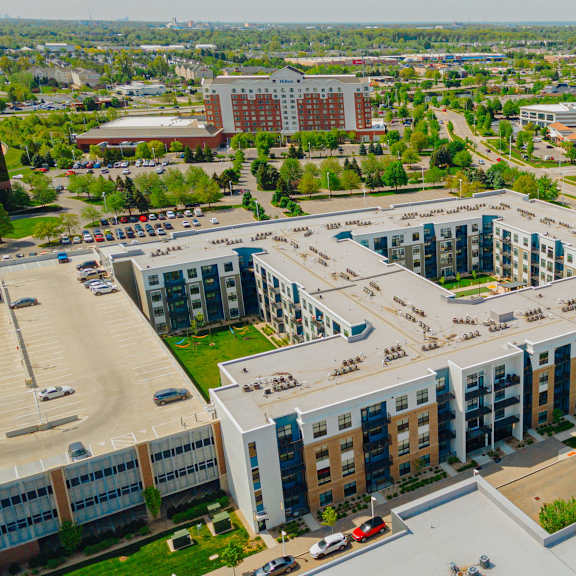 an aerial view of a city with several buildings and a parking lot