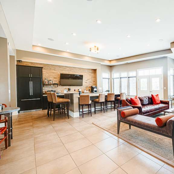 a living room with a couch and a table with chairs
