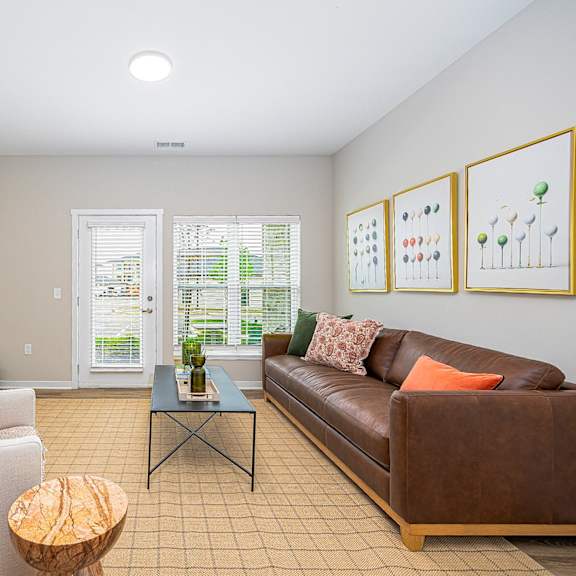 a living room with a leather couch and a coffee table