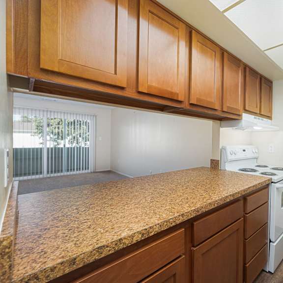 a kitchen with a granite counter top and white appliances