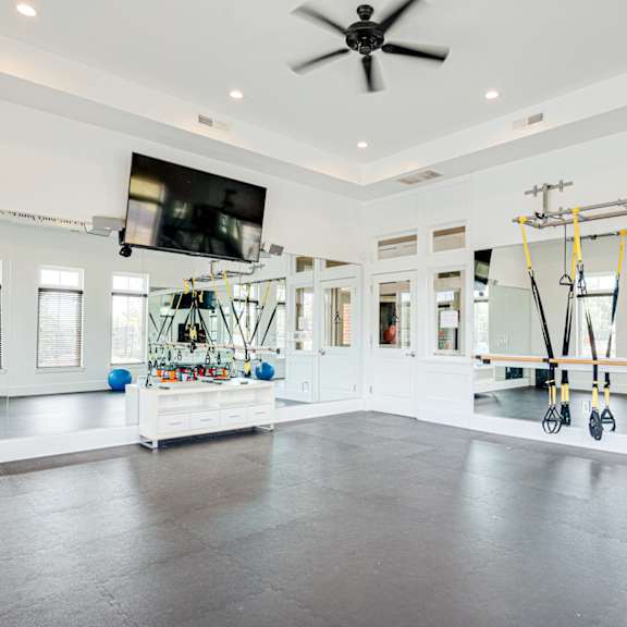 a home gym with weights and a tv on the wall