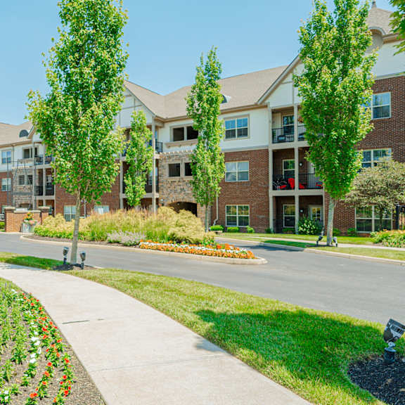 an apartment building on a street with sidewalks and trees