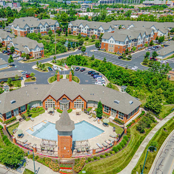 an aerial view of a building with a pool in a parking lot