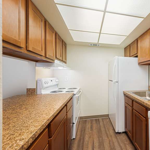 our apartments have a kitchen with granite counter tops and white appliances